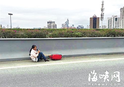 女子被拽下后，坐在三環(huán)路應急車道上喝水